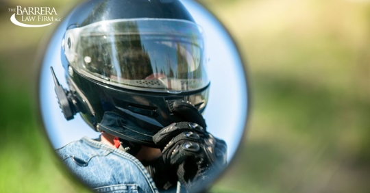 Reflection of a motorcyclists helmet in a motorcycle mirror